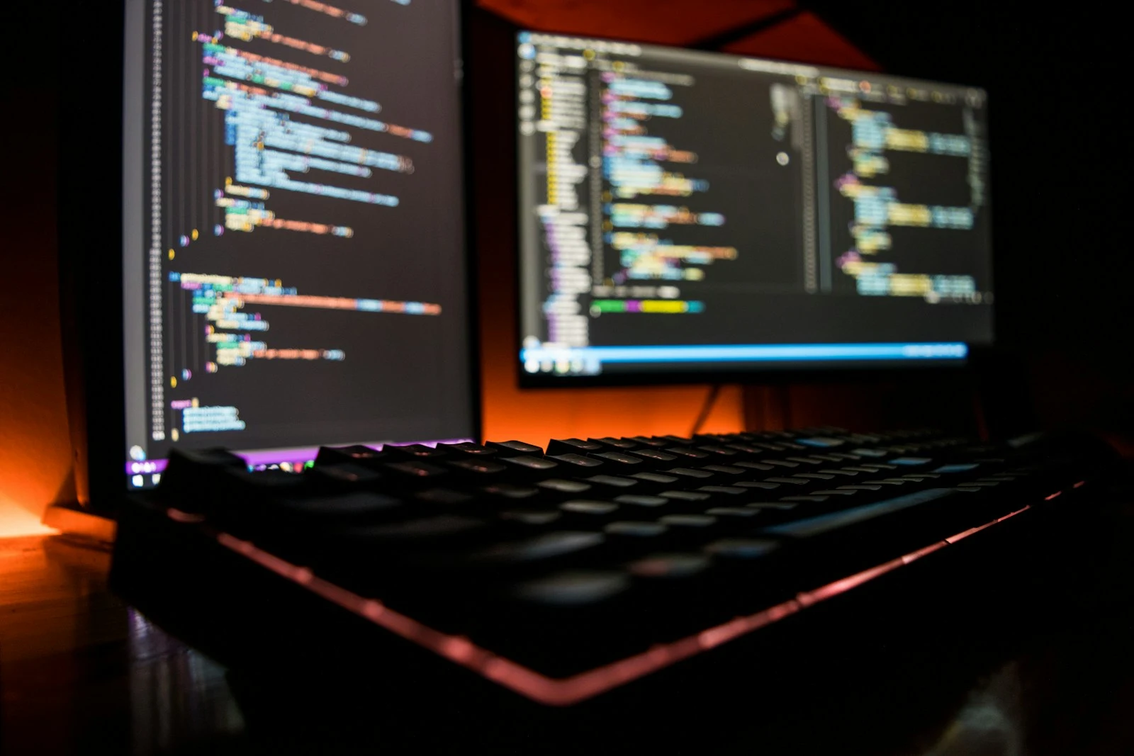 Code displayed across development monitors